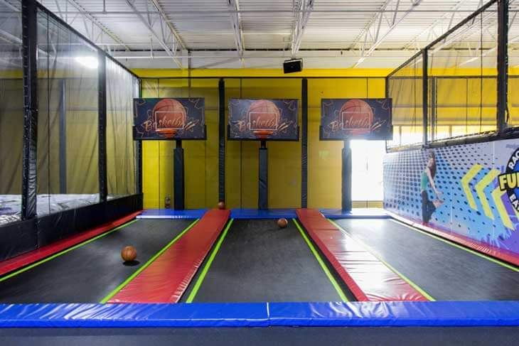 Trampoline dunk lanes with digital backboards