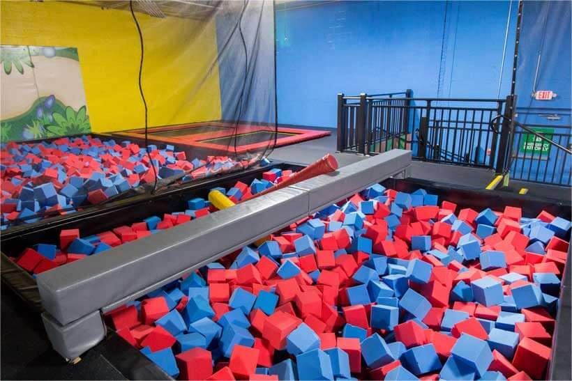 Foam pit filled with red and blue foam cubes