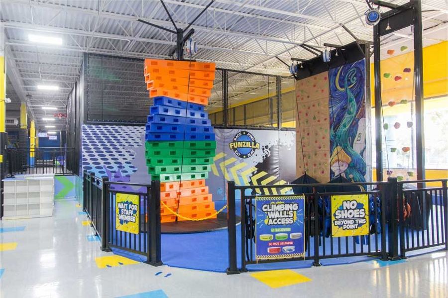 Twisting climbing tower and Funzilla logo wall